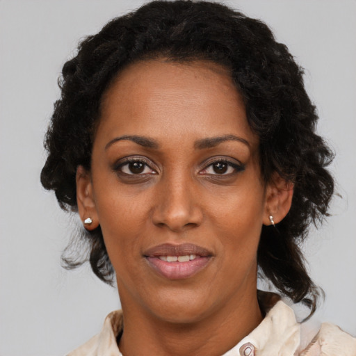 Joyful black adult female with medium  black hair and brown eyes