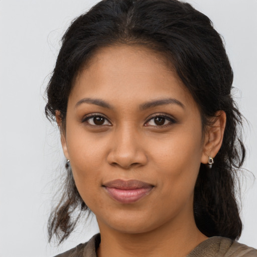 Joyful latino young-adult female with medium  brown hair and brown eyes