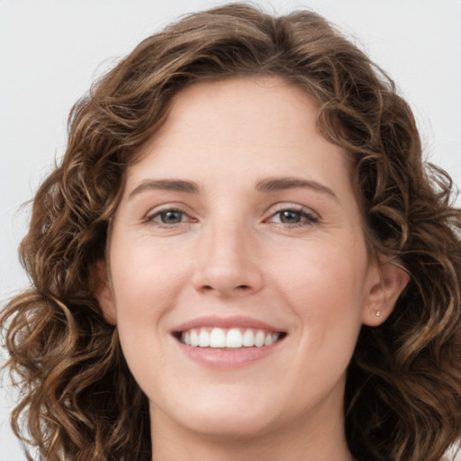 Joyful white young-adult female with long  brown hair and green eyes