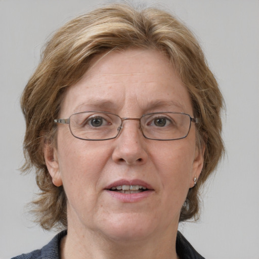 Joyful white middle-aged female with medium  brown hair and blue eyes