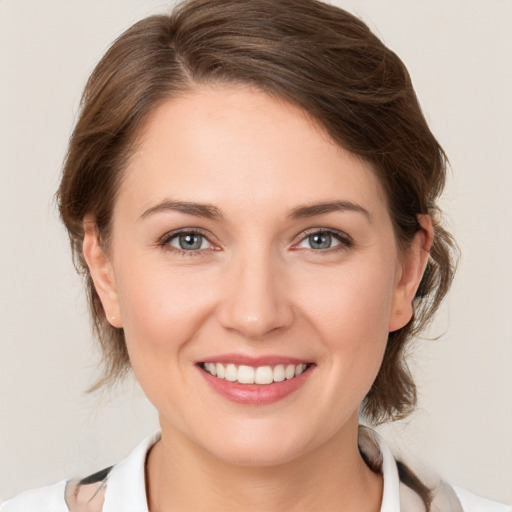 Joyful white young-adult female with medium  brown hair and grey eyes