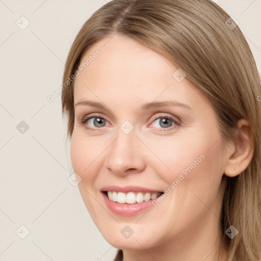 Joyful white young-adult female with long  brown hair and grey eyes