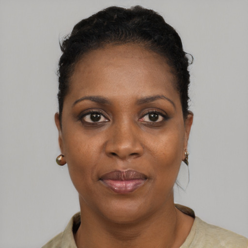 Joyful black adult female with short  black hair and brown eyes
