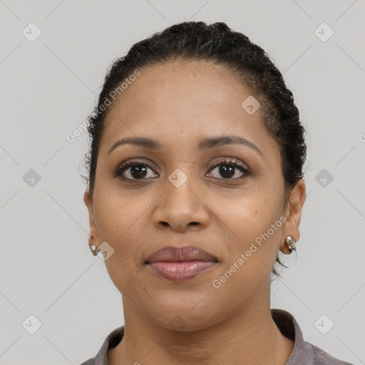 Joyful latino young-adult female with short  black hair and brown eyes