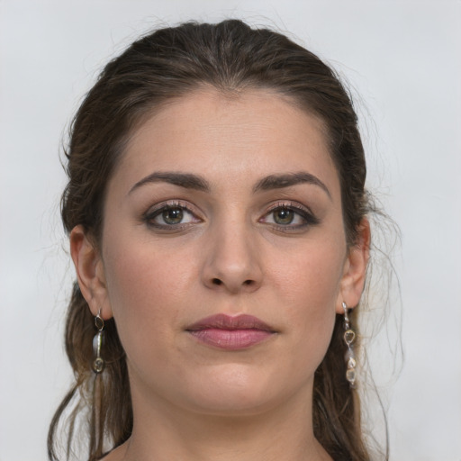 Joyful white young-adult female with long  brown hair and grey eyes