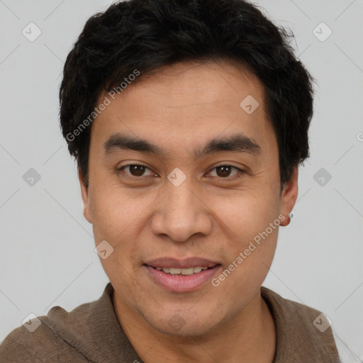 Joyful latino young-adult male with short  brown hair and brown eyes