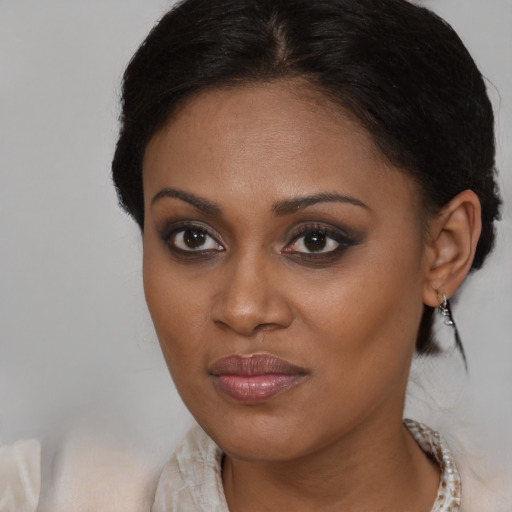 Joyful black young-adult female with medium  brown hair and brown eyes
