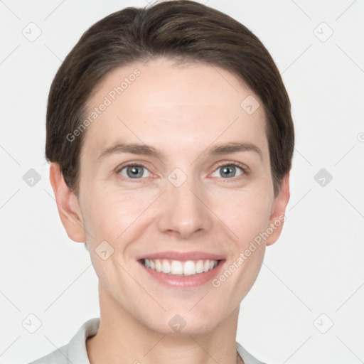 Joyful white young-adult female with short  brown hair and grey eyes