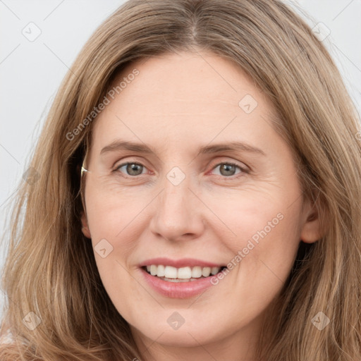 Joyful white young-adult female with long  brown hair and green eyes