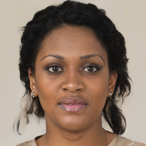 Joyful black young-adult female with medium  black hair and brown eyes