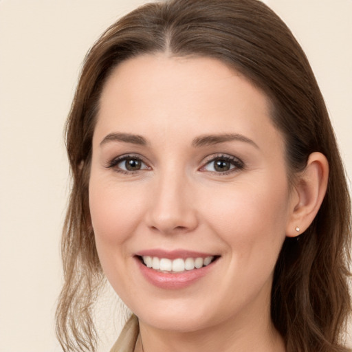 Joyful white young-adult female with long  brown hair and brown eyes