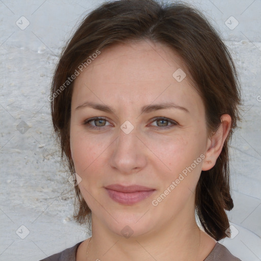 Joyful white adult female with medium  brown hair and grey eyes