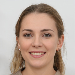 Joyful white young-adult female with long  brown hair and grey eyes