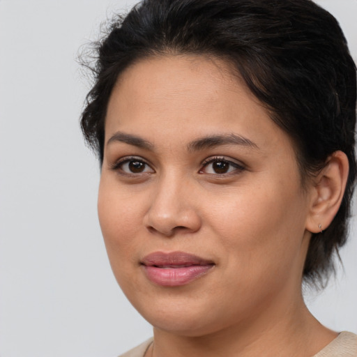 Joyful latino young-adult female with medium  brown hair and brown eyes