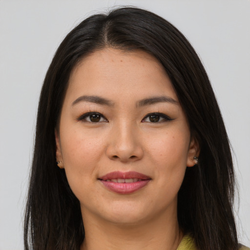 Joyful latino young-adult female with long  brown hair and brown eyes