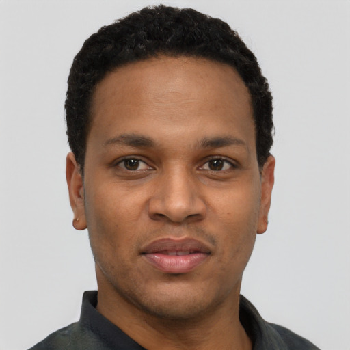 Joyful black young-adult male with short  black hair and brown eyes