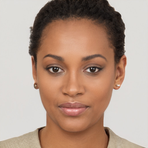 Joyful black young-adult female with short  brown hair and brown eyes