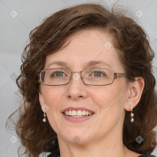 Joyful white adult female with medium  brown hair and blue eyes