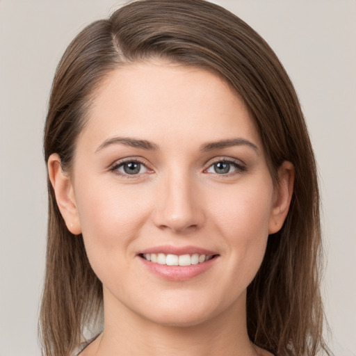 Joyful white young-adult female with long  brown hair and grey eyes