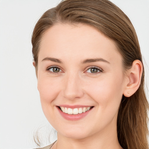 Joyful white young-adult female with long  brown hair and grey eyes