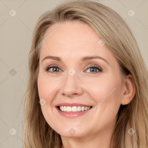 Joyful white adult female with long  brown hair and grey eyes