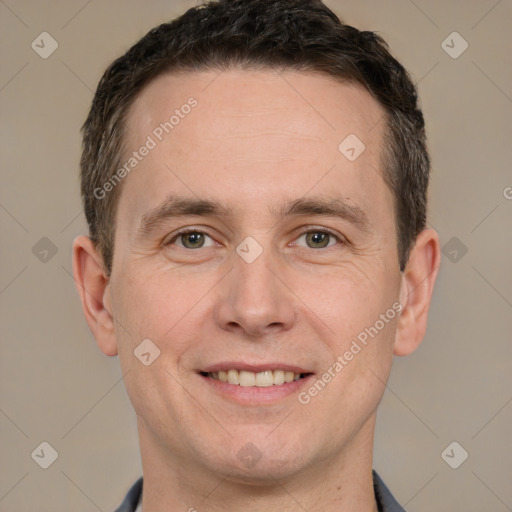 Joyful white adult male with short  brown hair and brown eyes