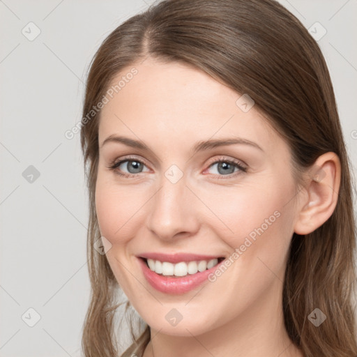 Joyful white young-adult female with long  brown hair and grey eyes