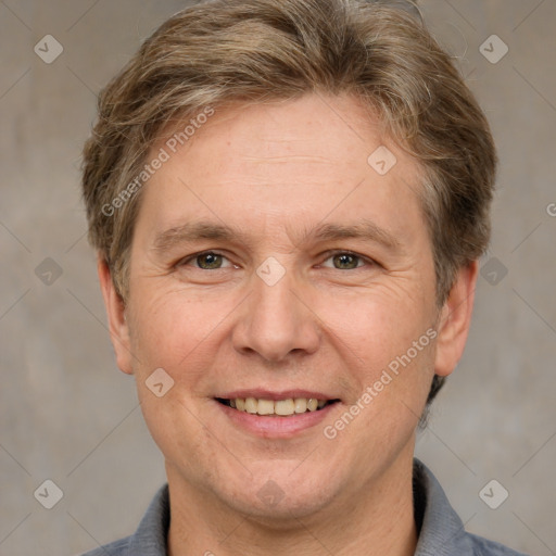 Joyful white adult male with short  brown hair and grey eyes