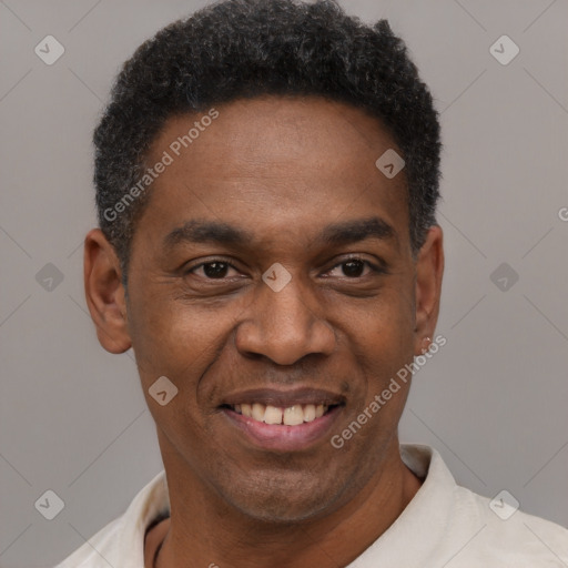 Joyful black young-adult male with short  black hair and brown eyes