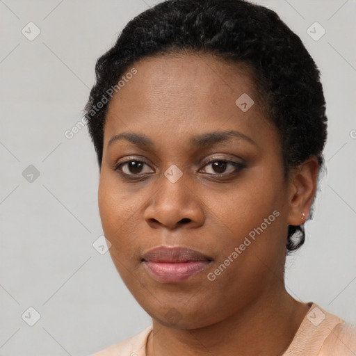 Joyful black young-adult female with short  black hair and brown eyes