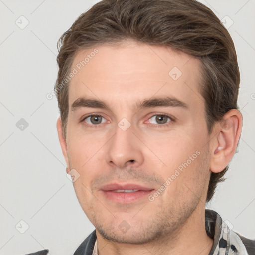 Joyful white young-adult male with short  brown hair and brown eyes