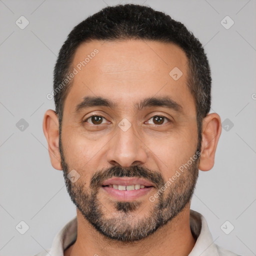 Joyful white adult male with short  black hair and brown eyes