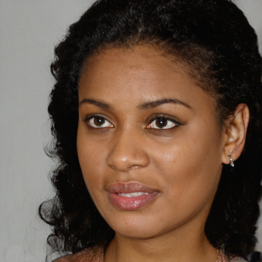 Joyful black young-adult female with medium  brown hair and brown eyes