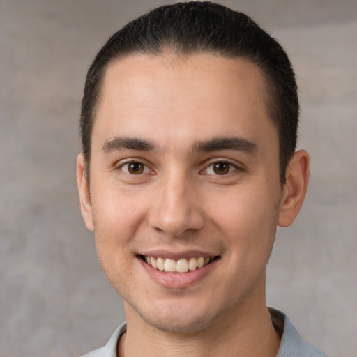 Joyful white young-adult male with short  brown hair and brown eyes