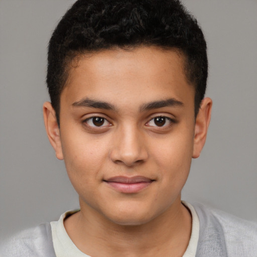 Joyful latino child male with short  brown hair and brown eyes