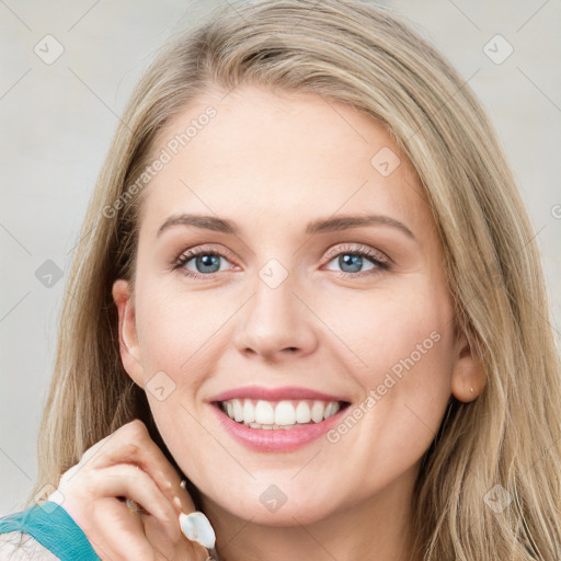 Joyful white young-adult female with long  brown hair and blue eyes