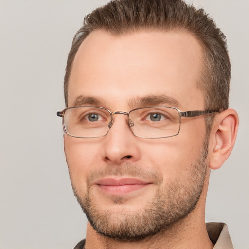 Joyful white adult male with short  brown hair and brown eyes