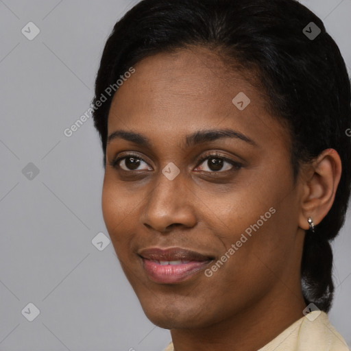 Joyful black young-adult female with short  black hair and brown eyes