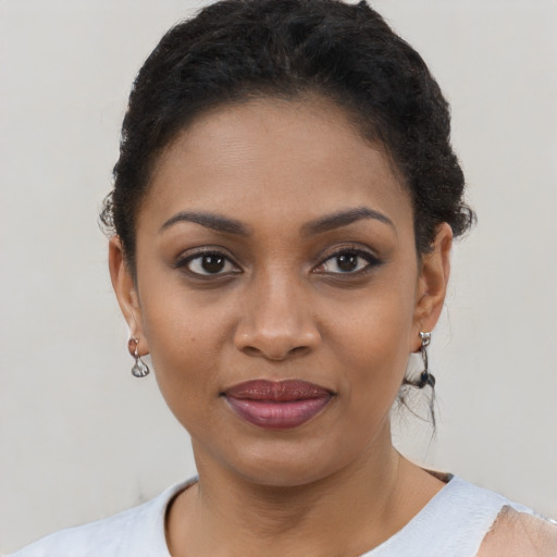 Joyful black young-adult female with short  brown hair and brown eyes