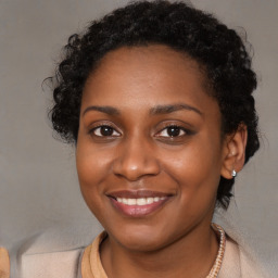 Joyful black young-adult female with long  brown hair and brown eyes