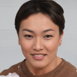 Joyful asian young-adult female with short  brown hair and brown eyes