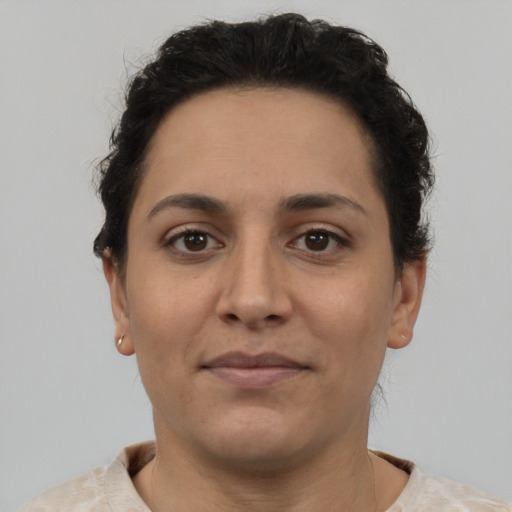 Joyful latino young-adult female with short  brown hair and brown eyes