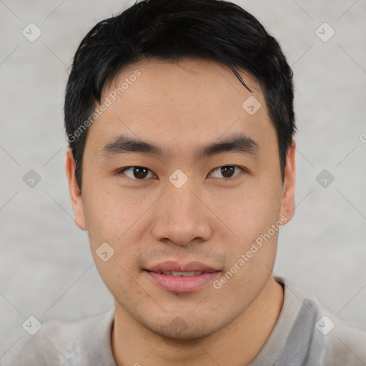 Joyful asian young-adult male with short  black hair and brown eyes