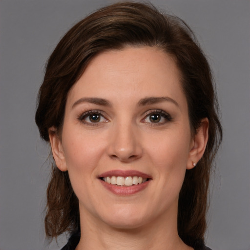 Joyful white young-adult female with medium  brown hair and brown eyes