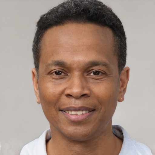 Joyful black adult male with short  brown hair and brown eyes