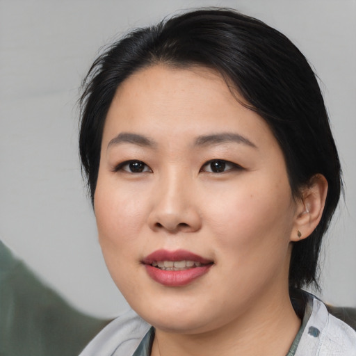 Joyful asian young-adult female with medium  black hair and brown eyes
