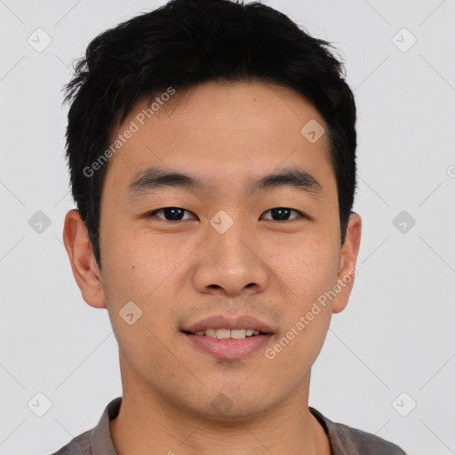 Joyful asian young-adult male with short  black hair and brown eyes