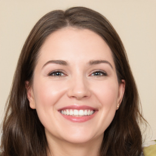 Joyful white young-adult female with long  brown hair and brown eyes