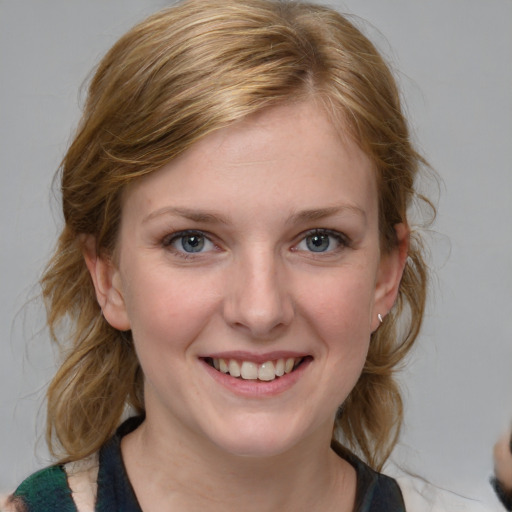 Joyful white young-adult female with medium  brown hair and blue eyes