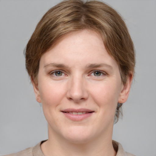 Joyful white young-adult female with medium  brown hair and grey eyes